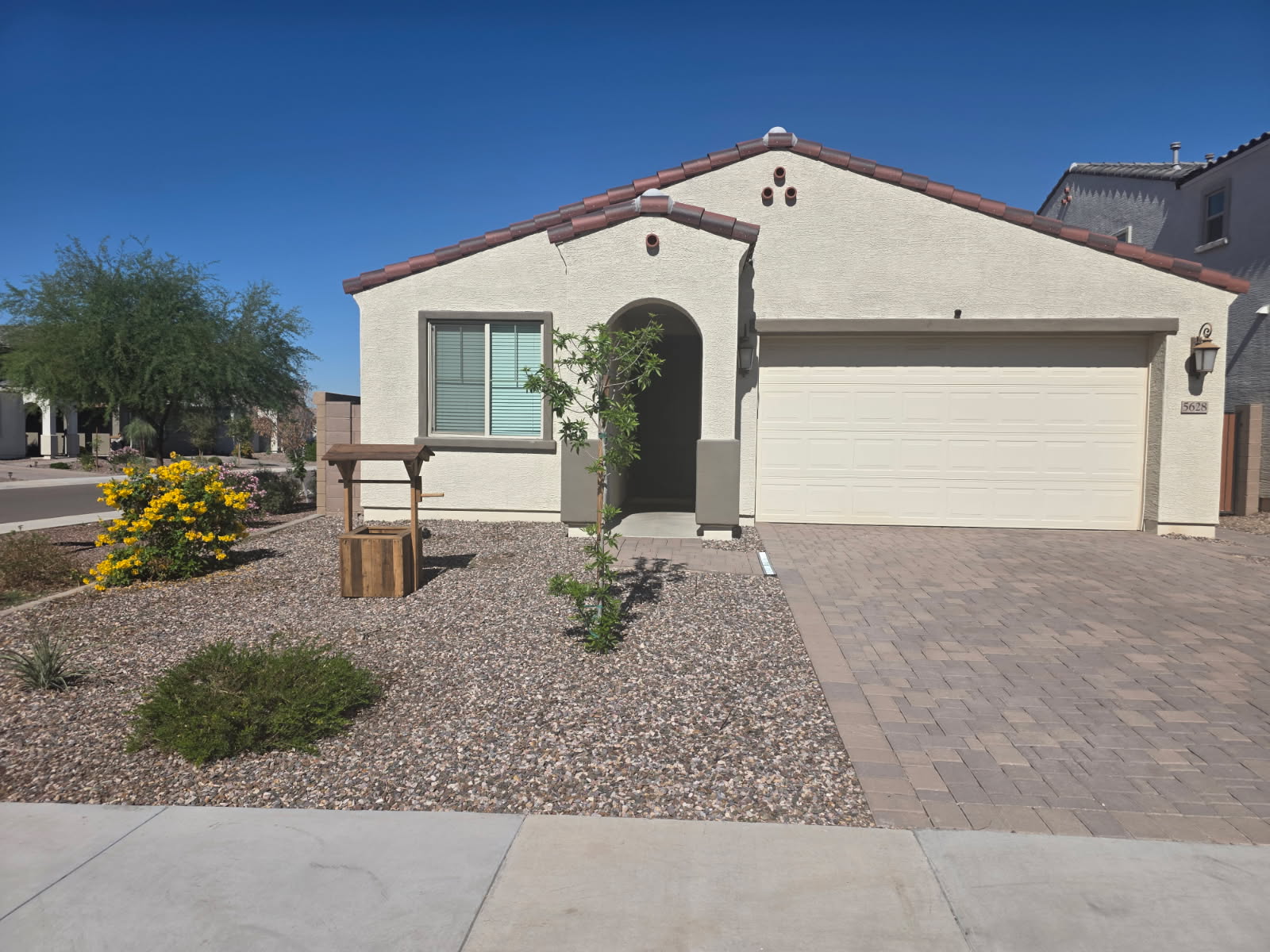 A single-story residential home with a landscaped front yard